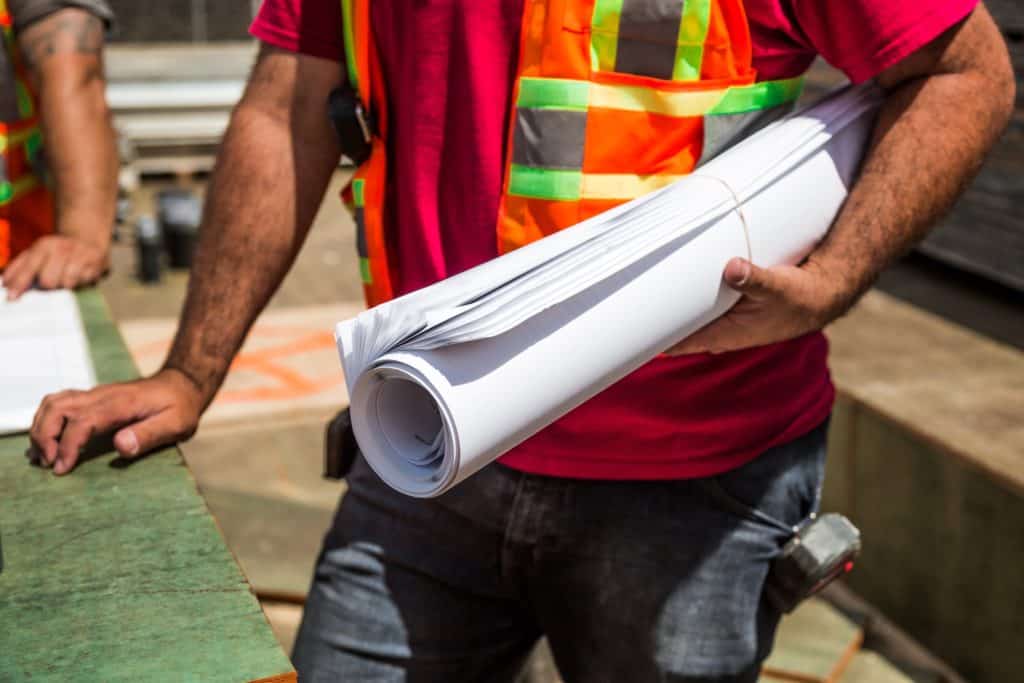 Worker Holding Drawing Roll