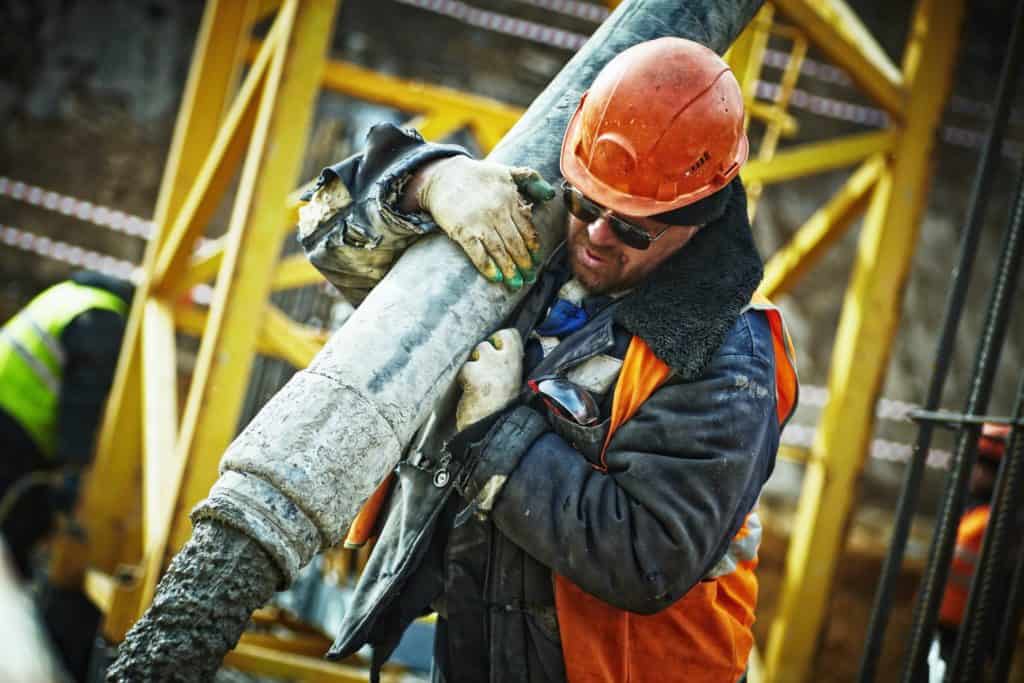 Concrete worker on end of hose