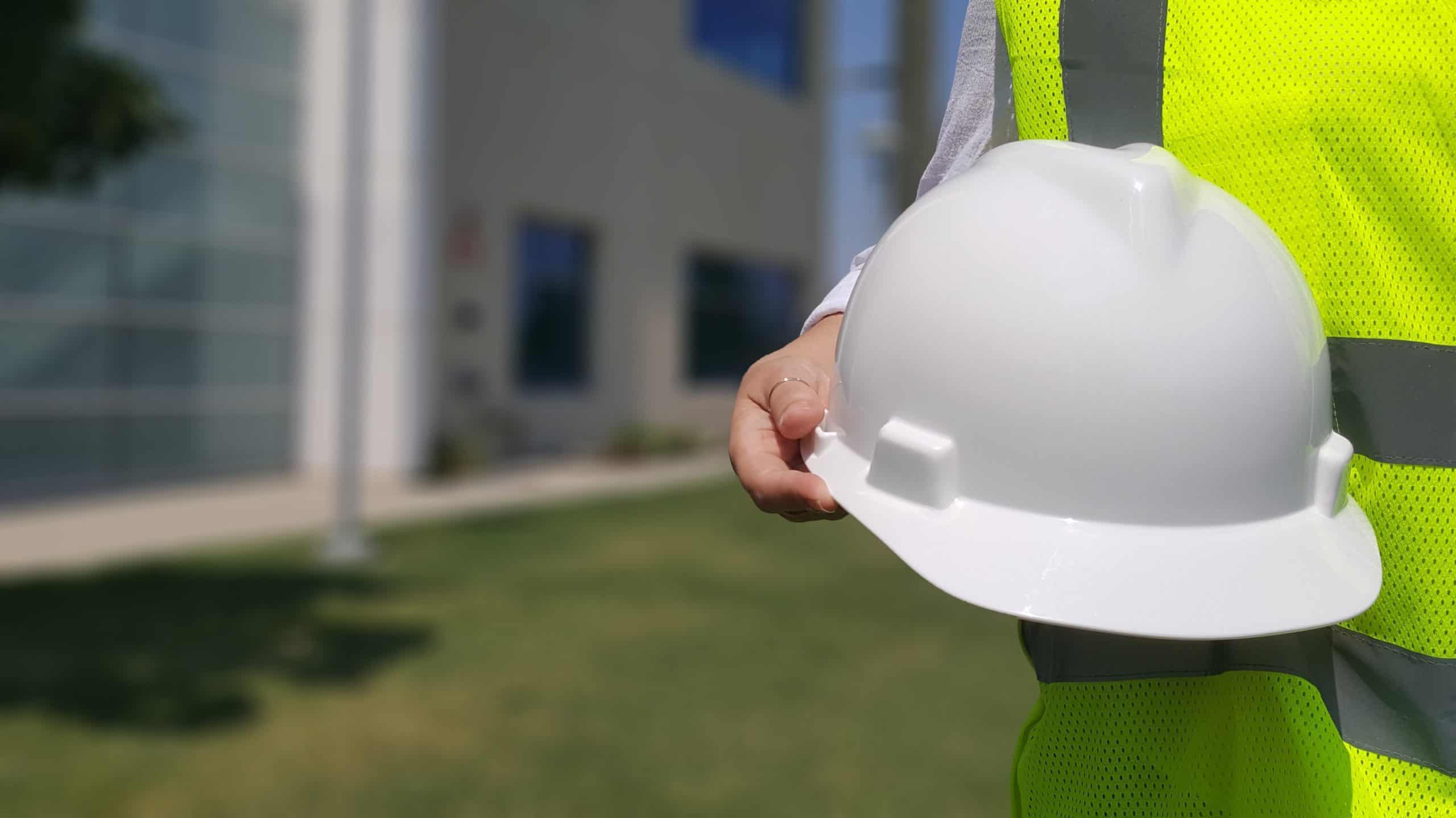 Worker holding white hardhat