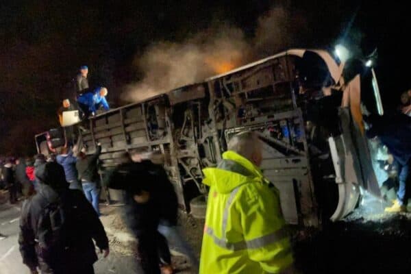Workmates from a following bus start to free trapped people before emergency services arrived