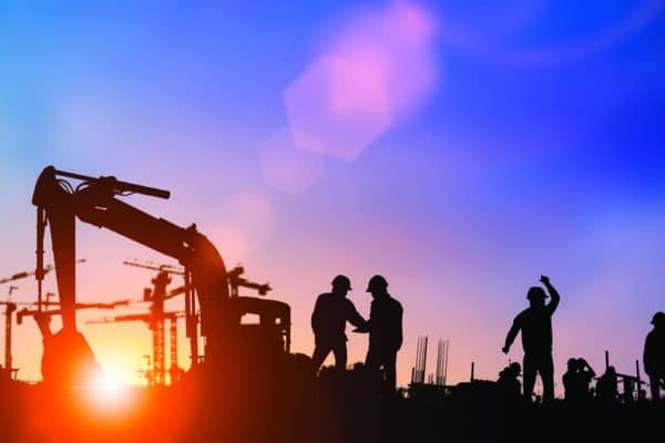 Silhouette of engineer and construction team working at site.