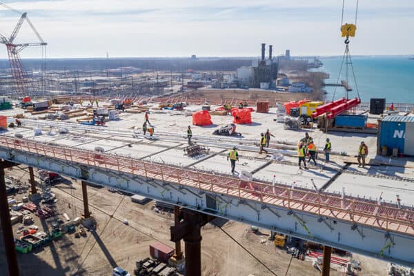 Towers almost complete as Gordie Howe bridge spans begin to cross river